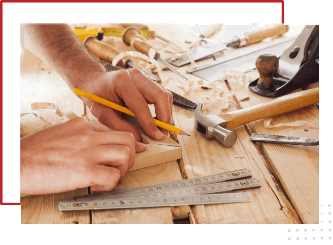 A person working on some wood with tools