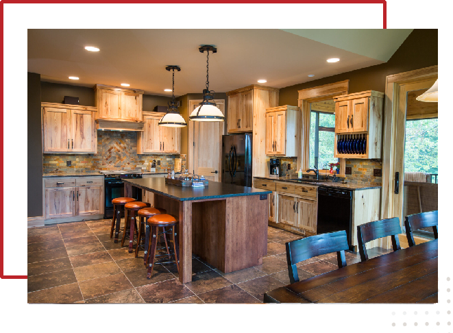 A kitchen with wooden cabinets and black counter tops.