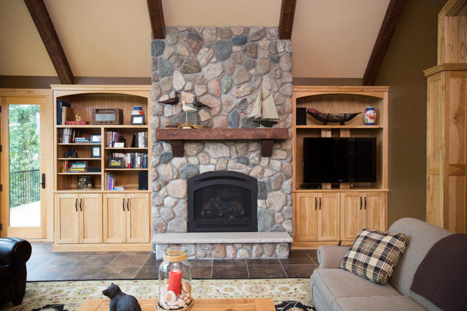 A living room with a fireplace and shelves