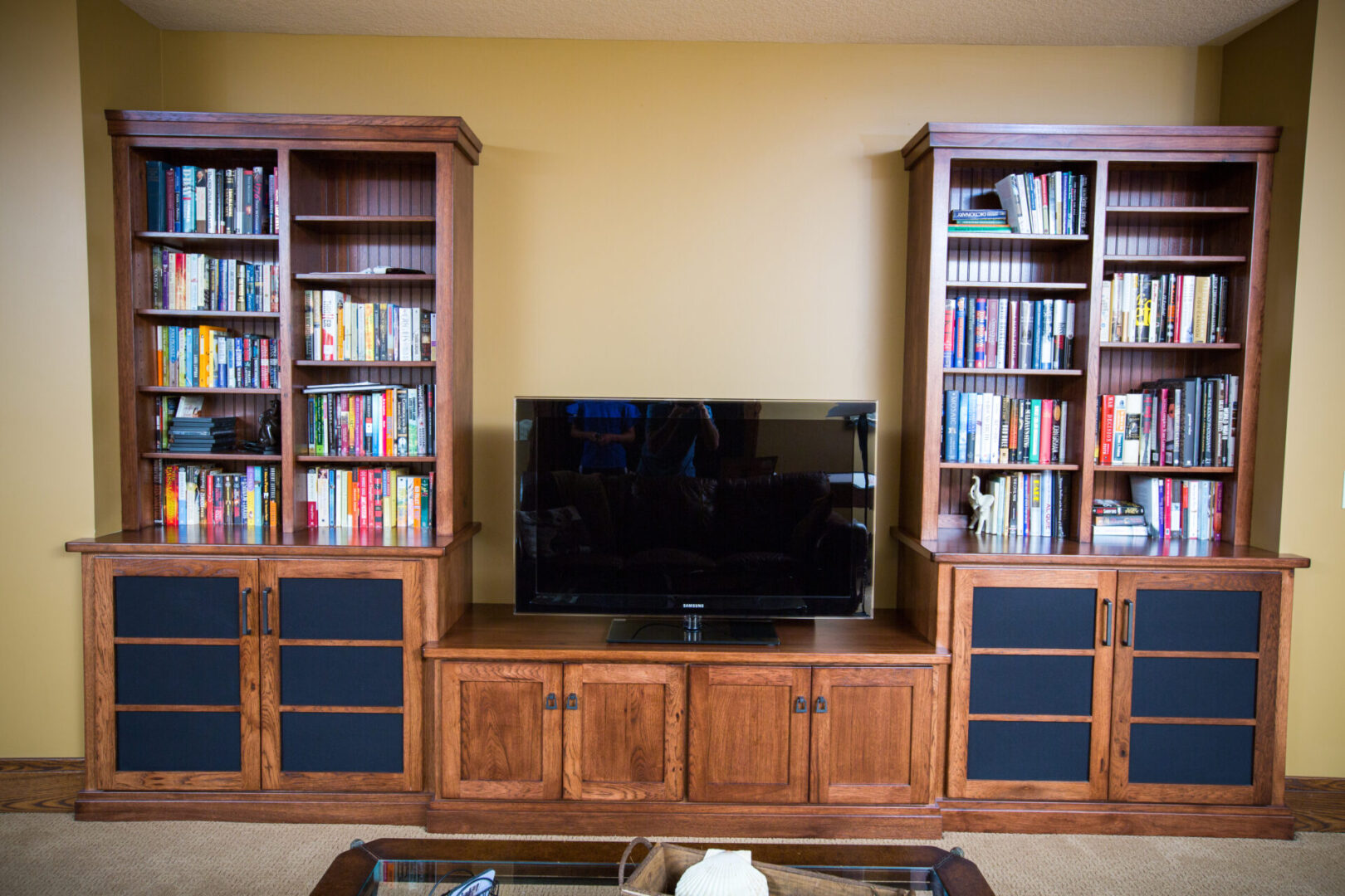 A television and some bookcases in a room.