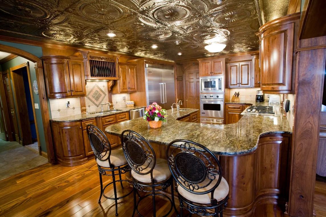 A kitchen with wooden cabinets and granite counter tops.