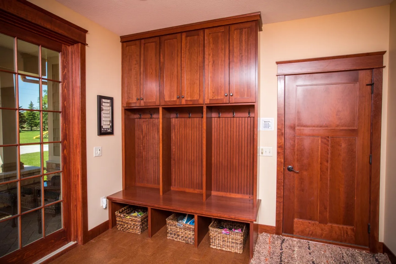 A wooden cabinet with baskets in front of it.