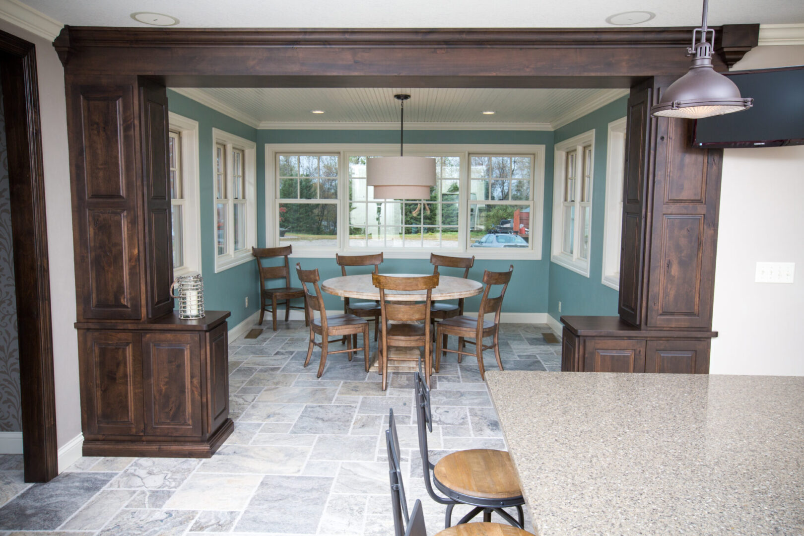 A dining room with blue walls and wooden furniture.