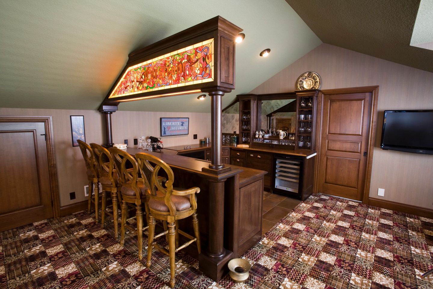 A bar with chairs and a clock on the wall.