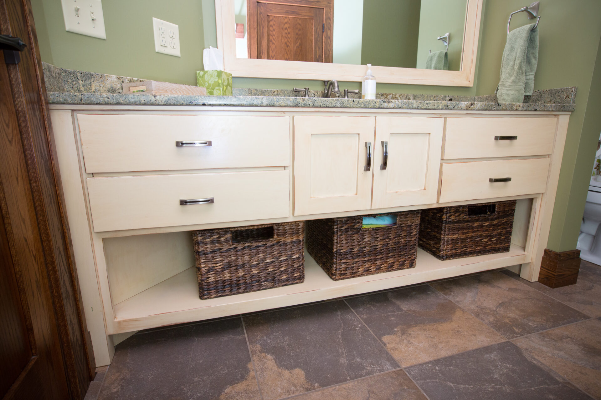 A bathroom with two sinks and three baskets.