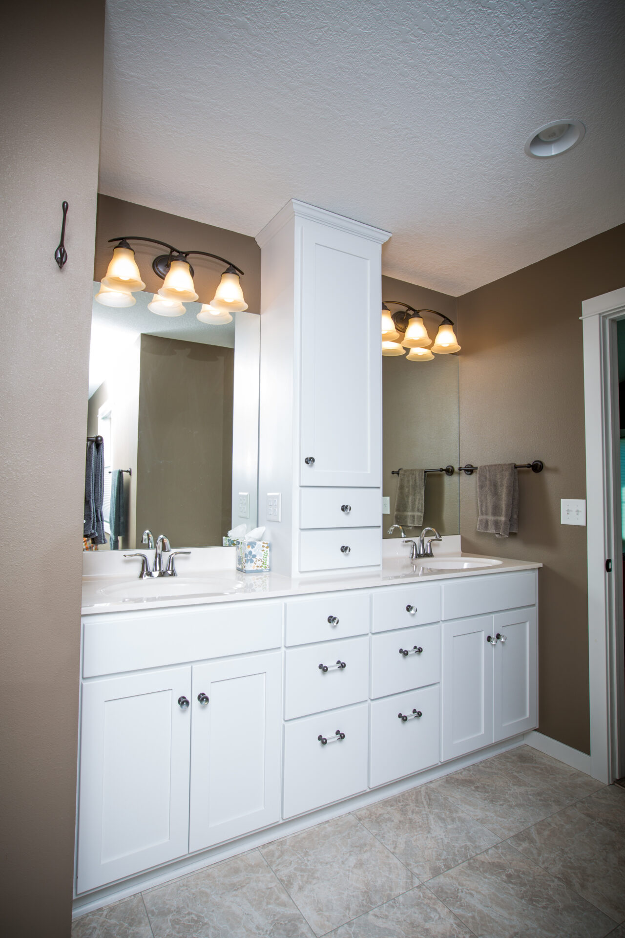 A bathroom with two sinks and a large mirror.