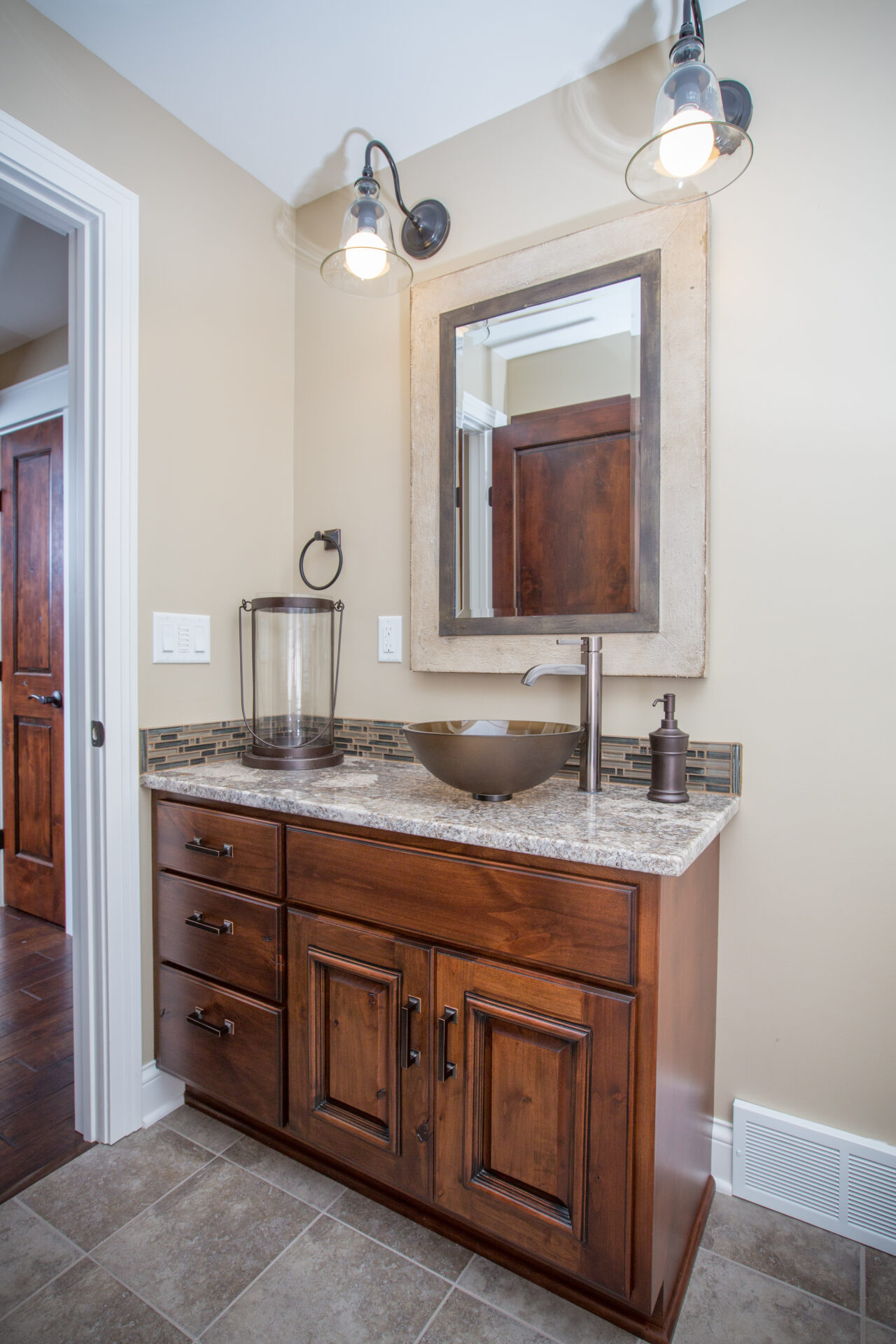 A bathroom with a sink and mirror in it