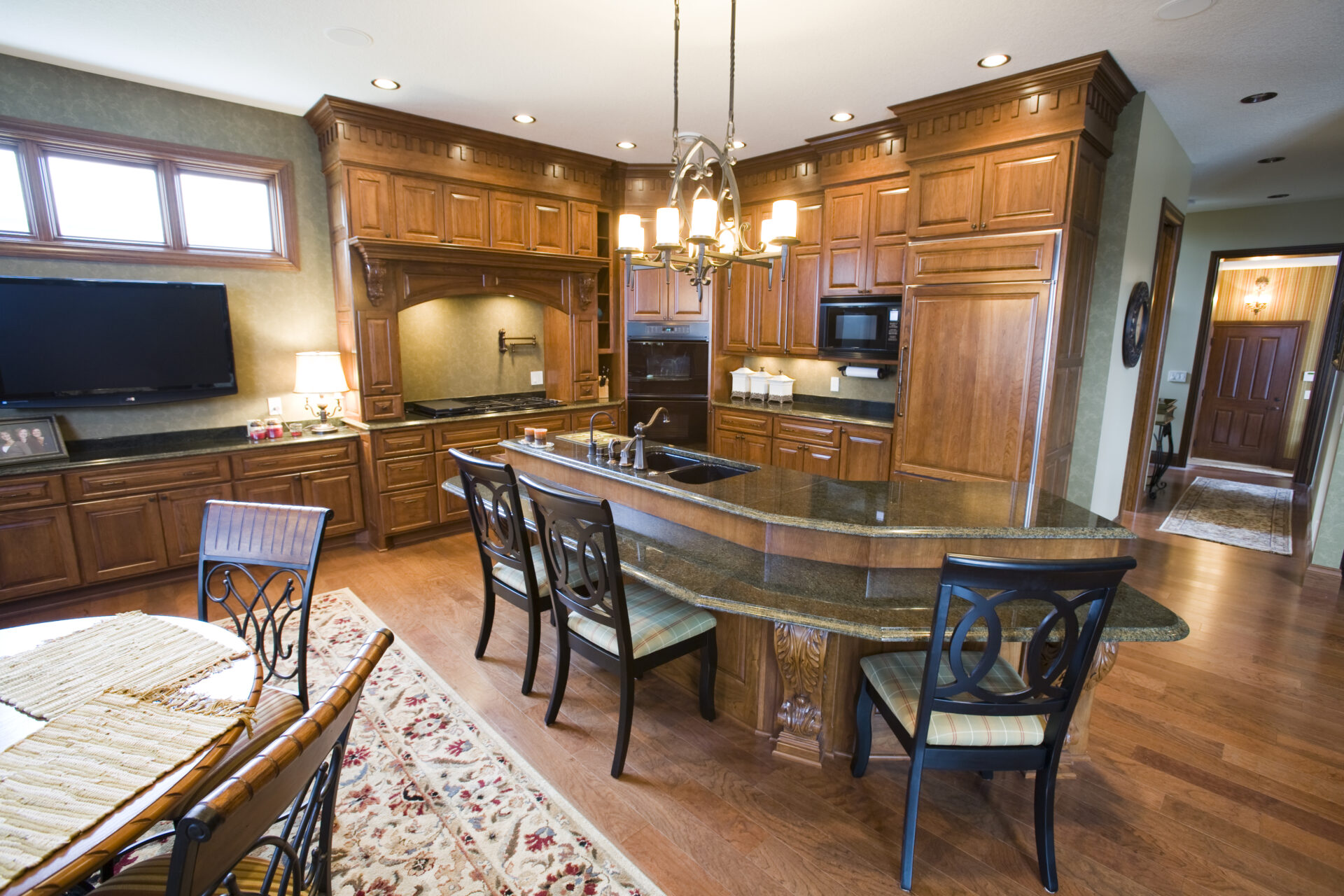 A kitchen with wooden cabinets and a dining table.