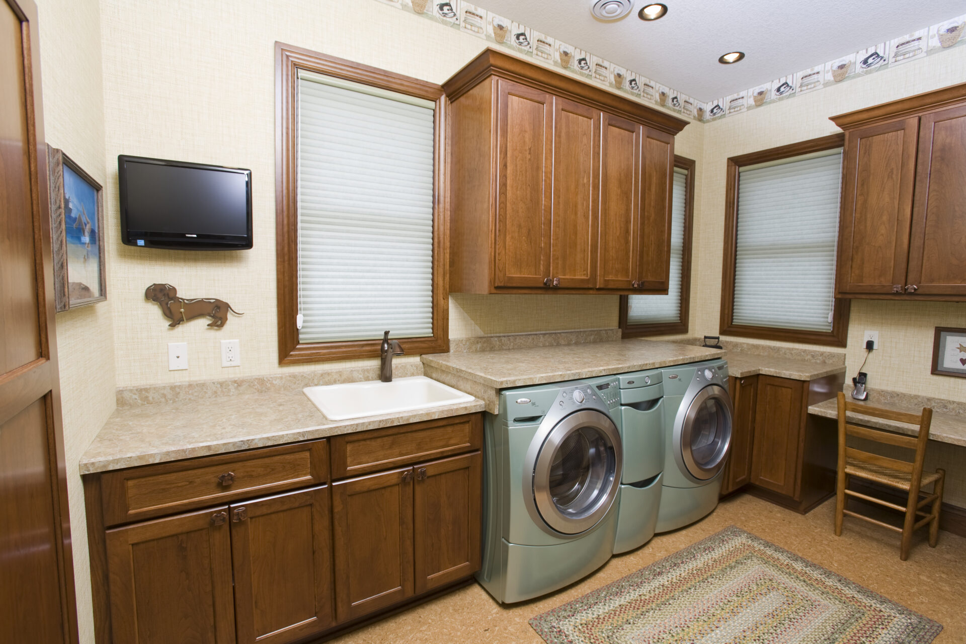 A kitchen with two washing machines and a sink