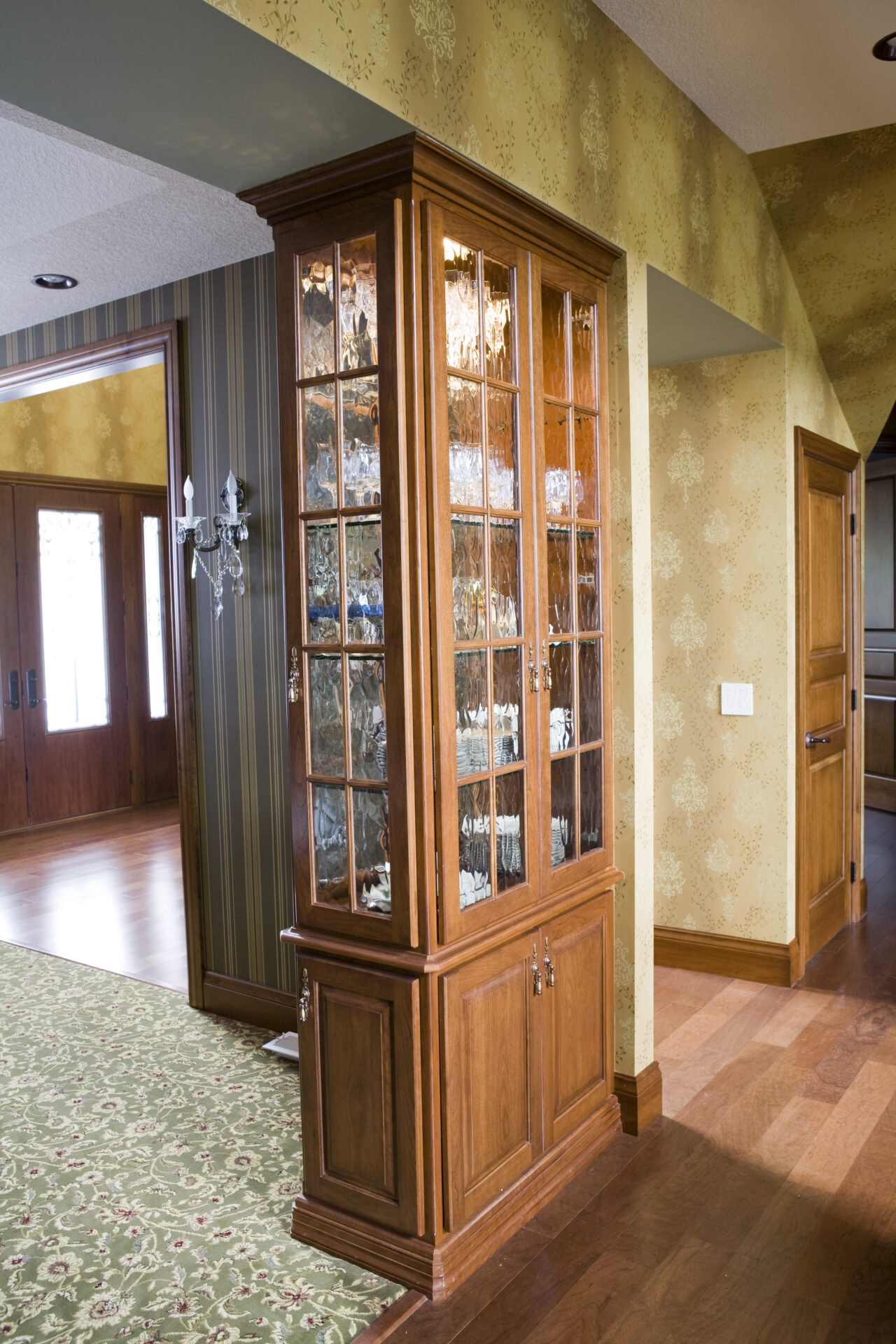 A corner cabinet with many pictures on it.