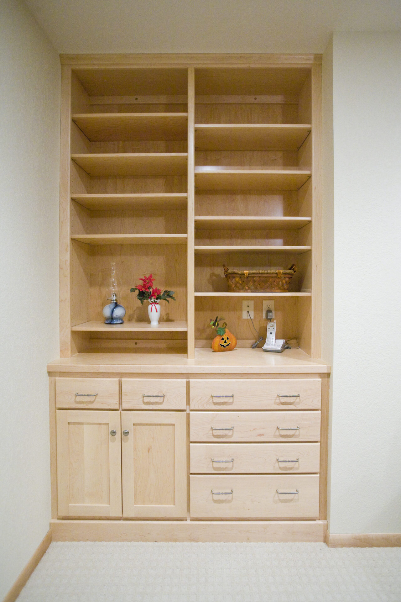 A wooden cabinet with shelves and drawers in it.