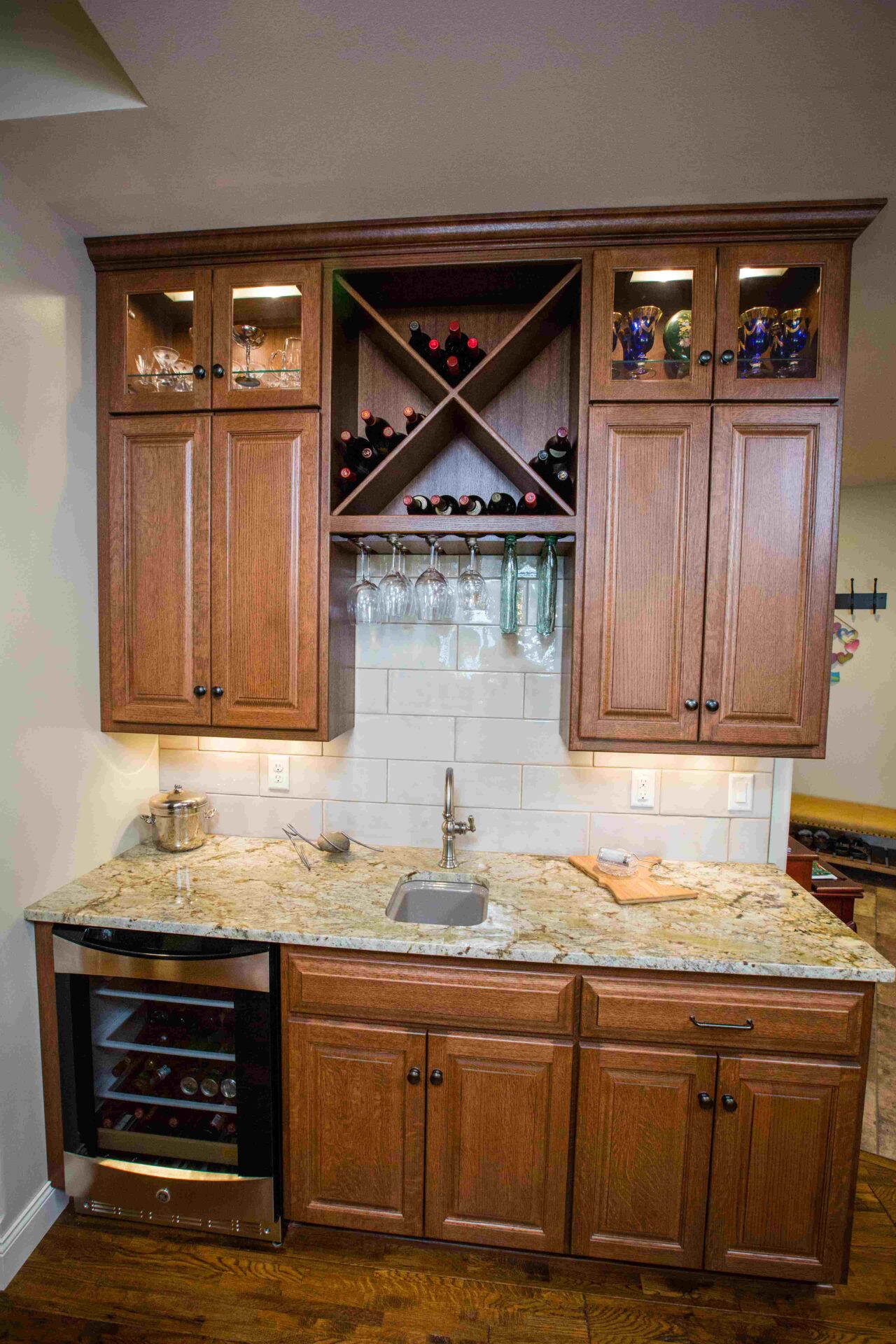 A kitchen with wooden cabinets and wine racks.